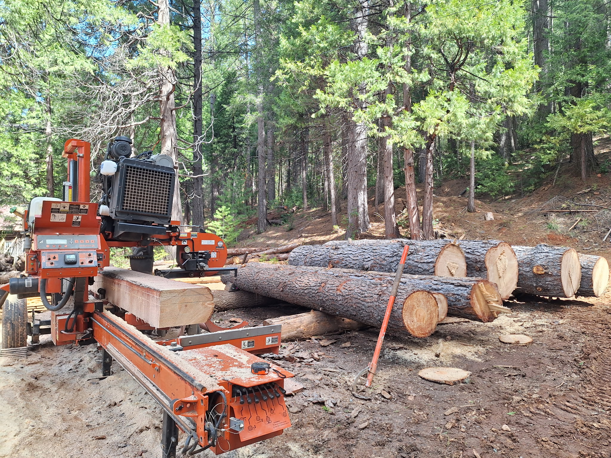 Long milled boards stacked outdoors.
